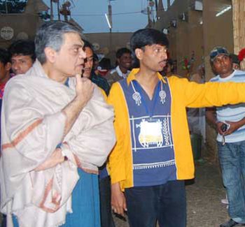 Sandip Ray watching the printed wall magazine of Nicwon- 'Nicwon Cholar Pathe' at the mela